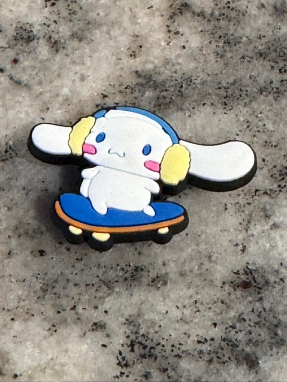 CROCS Jibbitz Charm White Character with Blue Skateboard and Yellow Ear Muffs